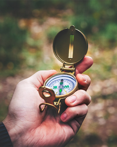 Hand holding a compass